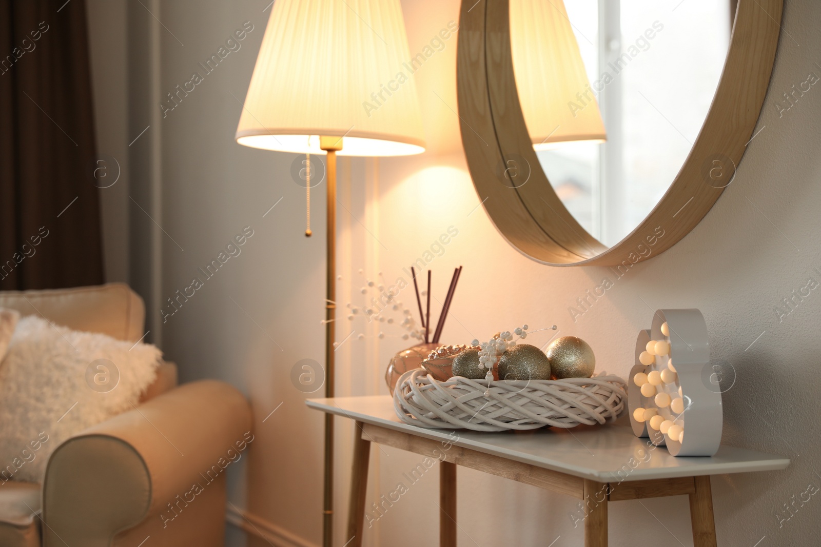 Photo of Beautiful room interior with round mirror and Christmas decor