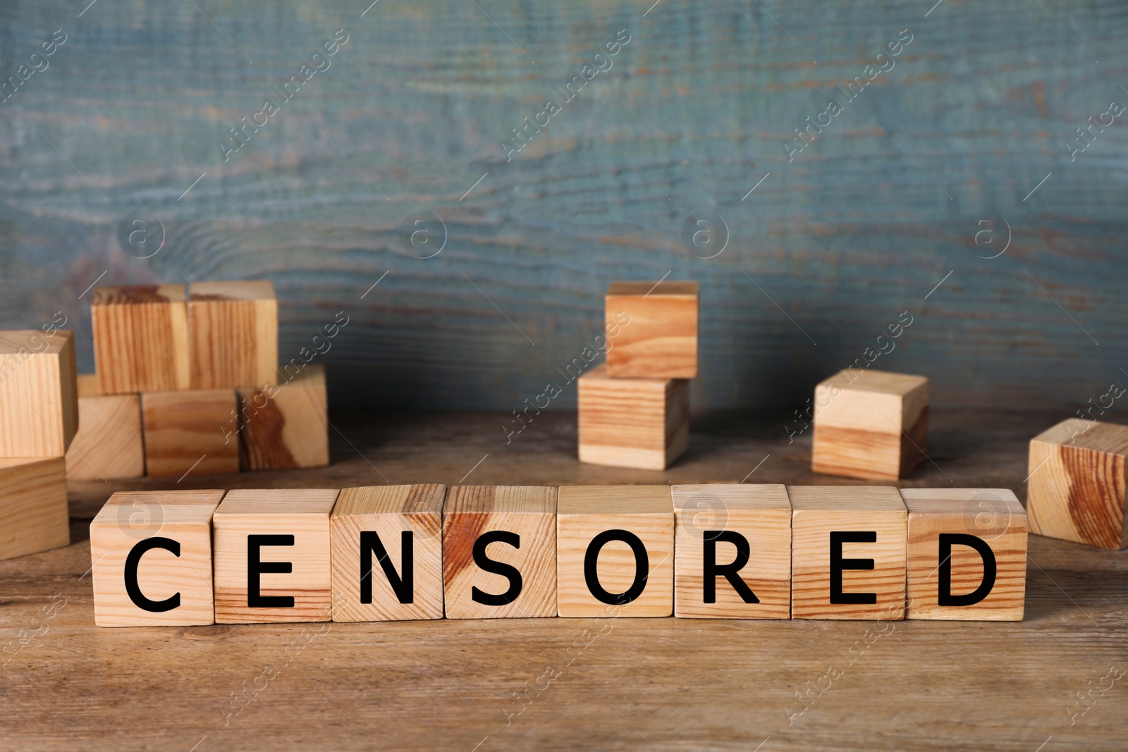 Photo of Cubes with word Censored on wooden table, space for text