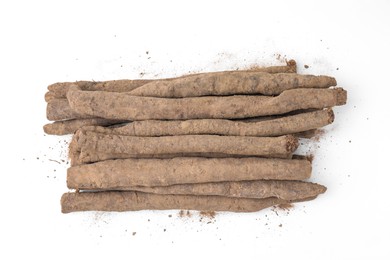 Fresh raw salsify roots on white background, flat lay