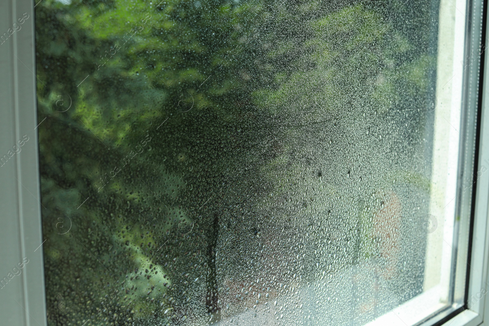 Photo of Window glass with water drops, closeup. Condensation