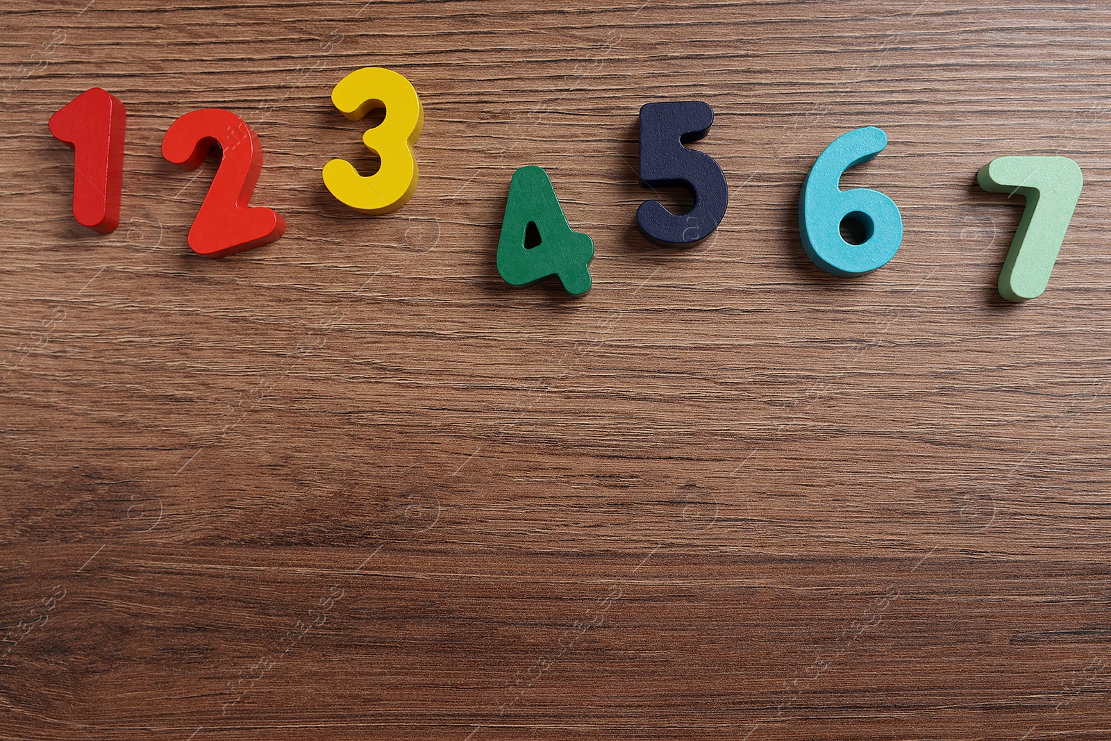 Photo of Math game with numbers on wooden table, flat lay. Space for text