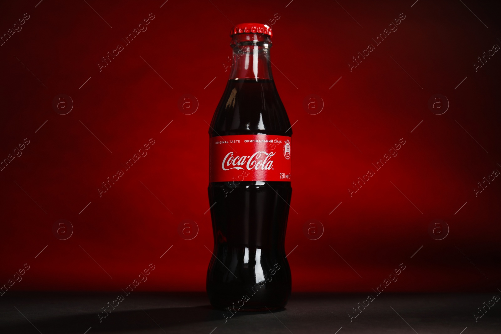 Photo of MYKOLAIV, UKRAINE - NOVEMBER 14, 2018: Bottle of Coca-Cola on color background