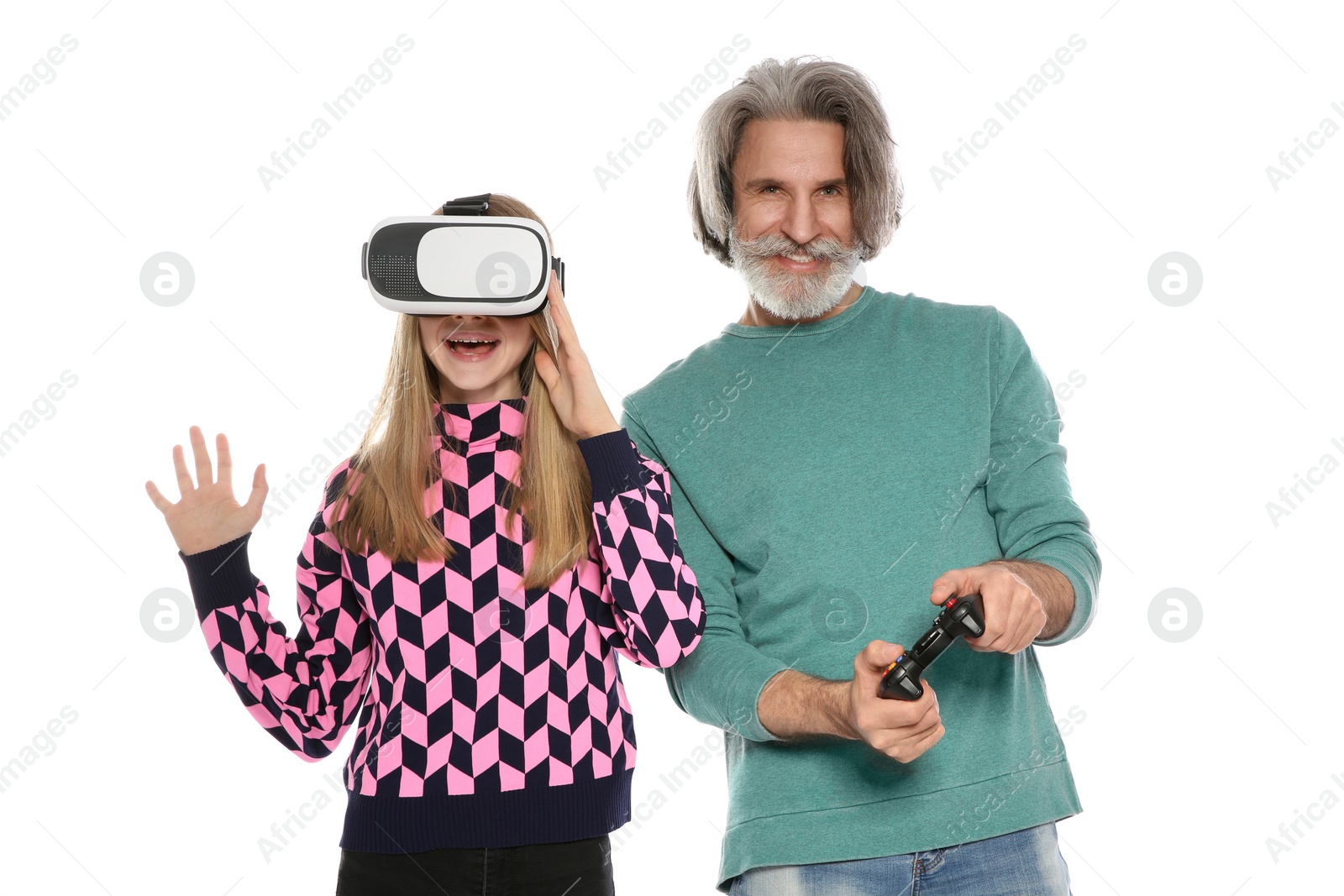 Photo of Teenage girl wearing VR headset and mature man with controller playing video games on white background