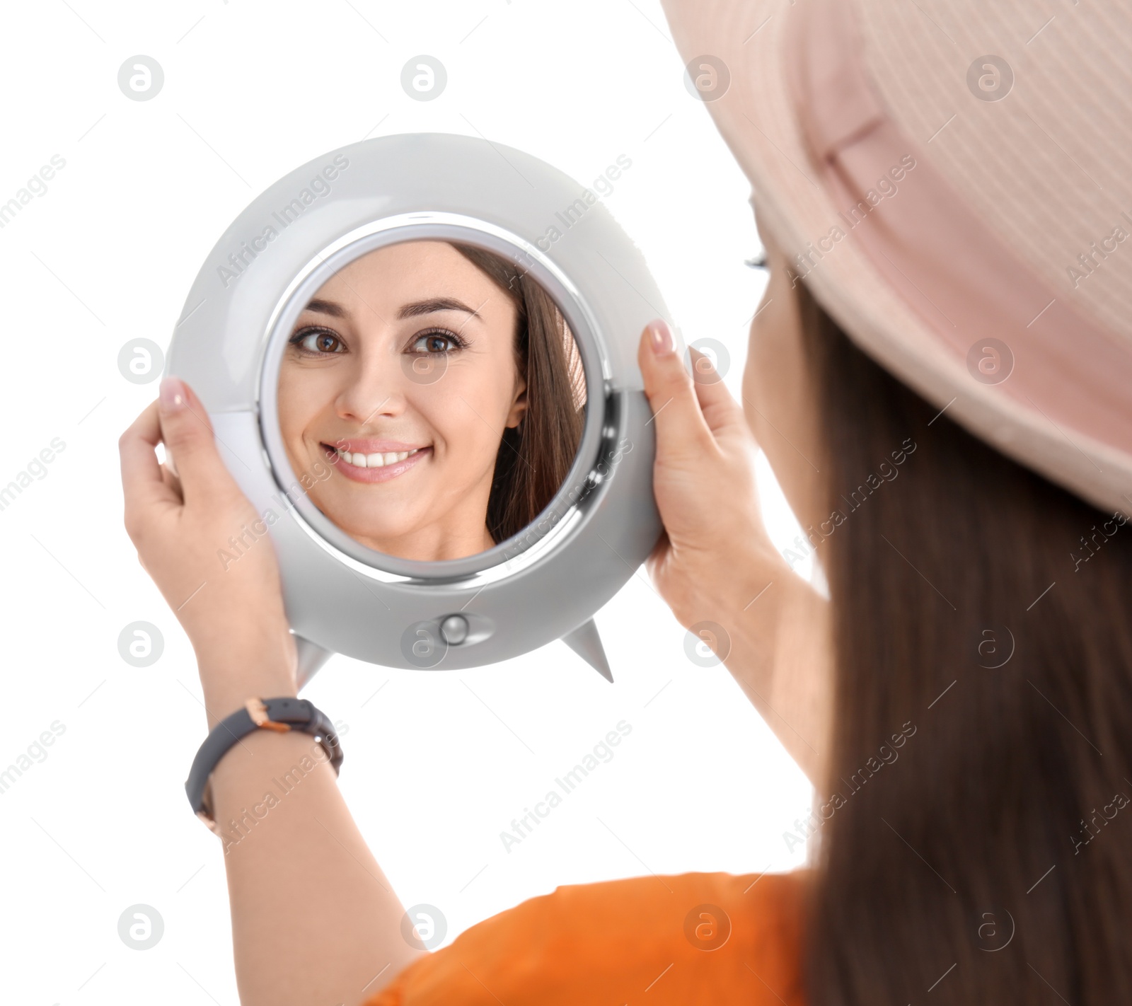 Photo of Young woman looking at her reflection in mirror on white background