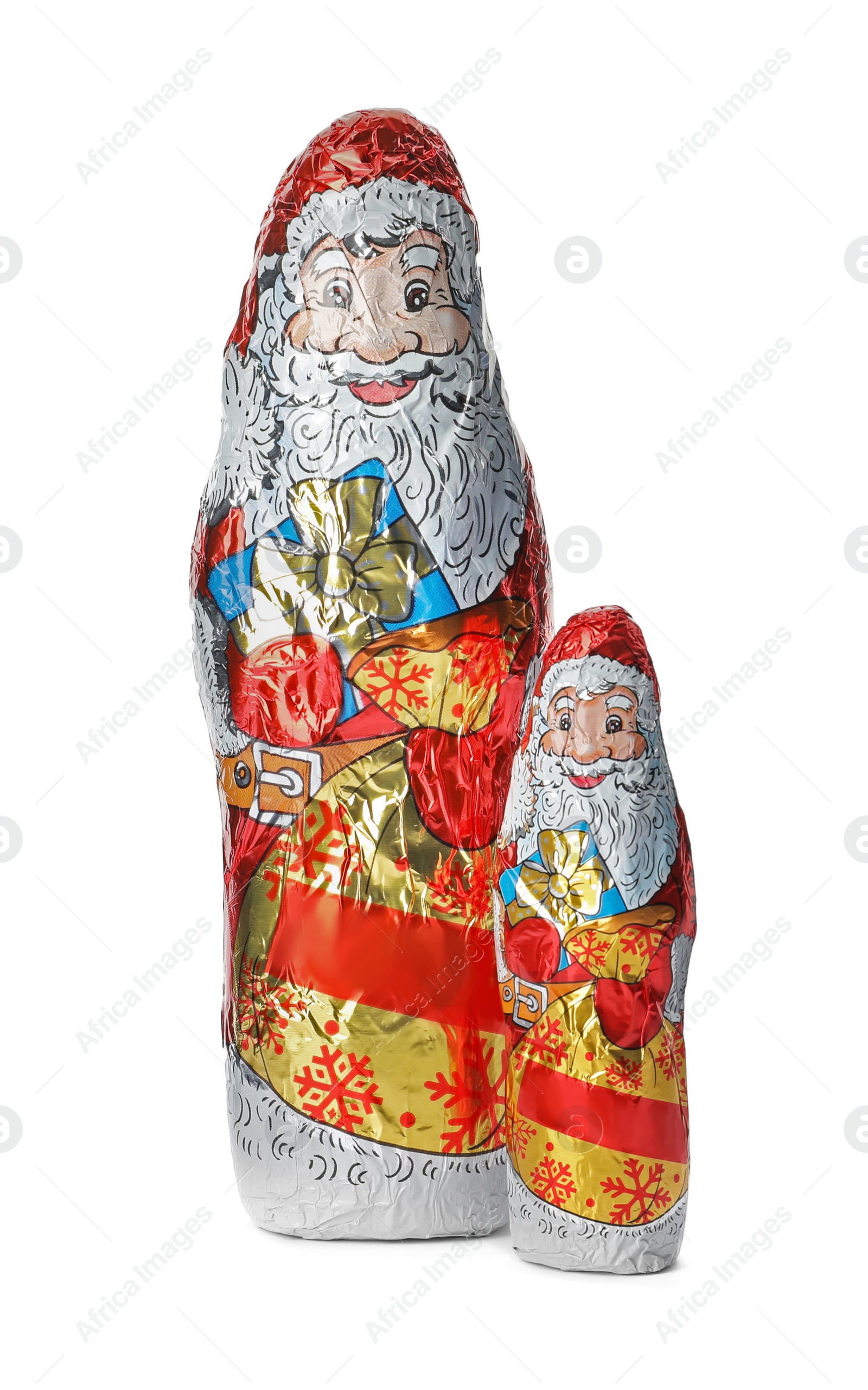 Photo of Chocolate Santa Claus figures in foil wrappers on white background