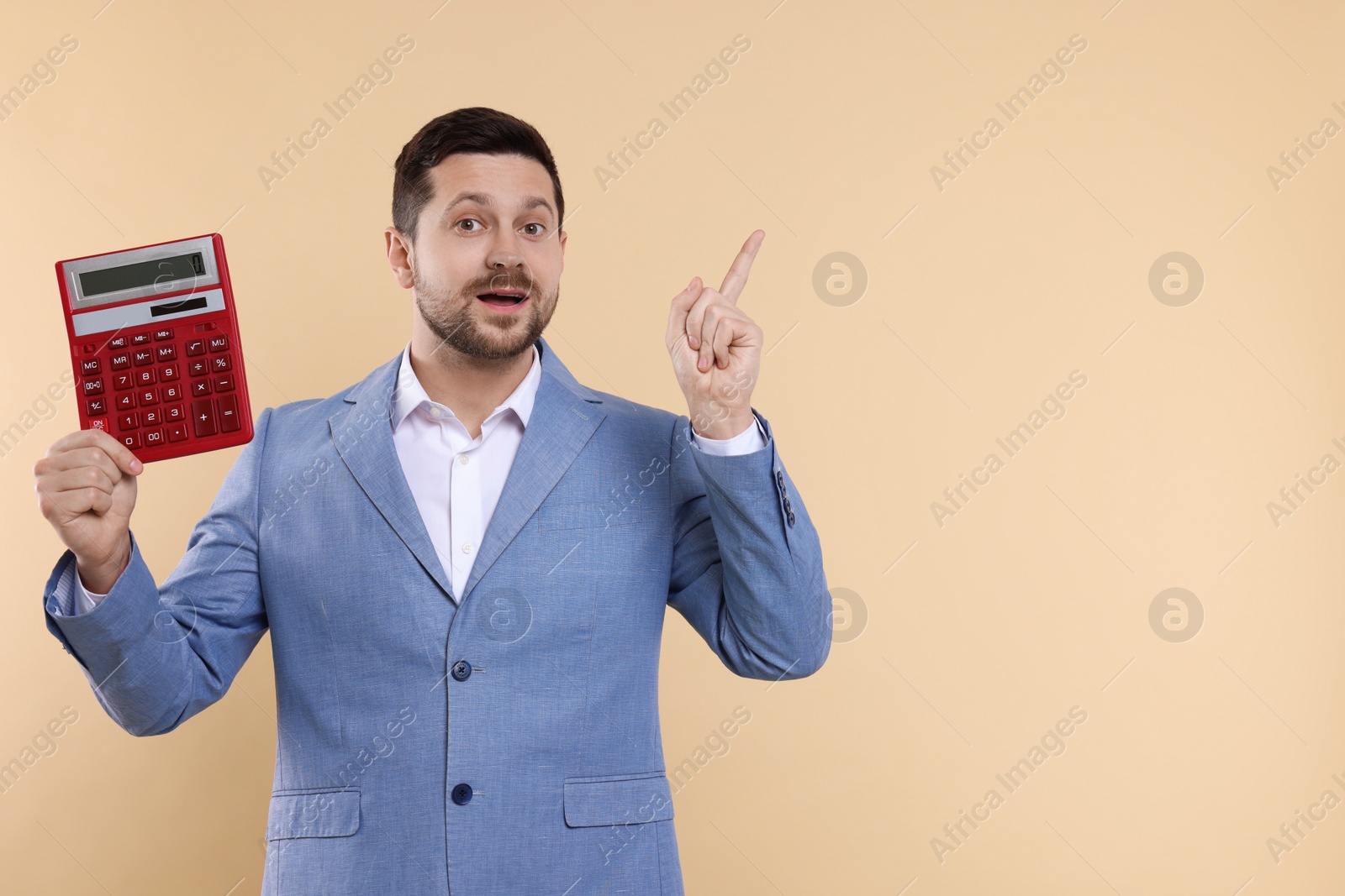 Photo of Emotional accountant with calculator on beige background. Space for text