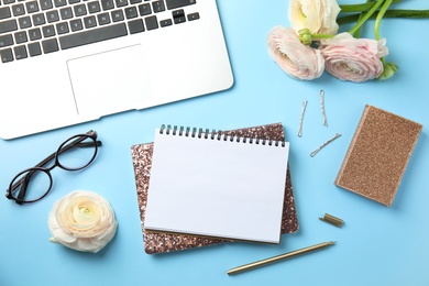 Photo of Flat lay composition with glittering notebooks and laptop on color background. Space for text