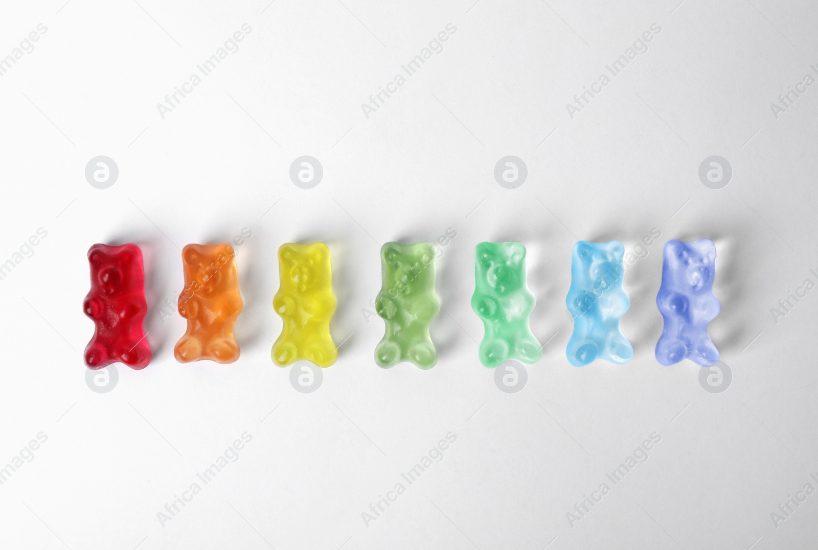 Photo of Delicious jelly bears on white background, top view