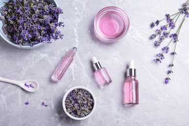 Photo of Flat lay composition with lavender essential oil on marble background