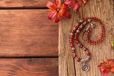Photo of Flat lay composition with beautiful gemstone necklace on wooden table, space for text