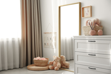 Photo of Modern room interior with white chest of drawers