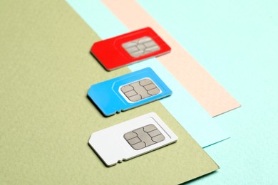 Photo of Different SIM cards on color background, closeup