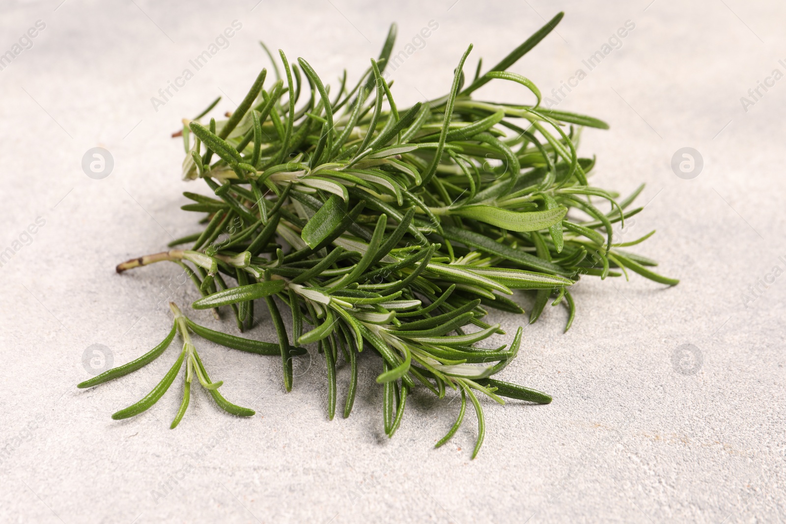 Photo of Fresh green rosemary on light textured table