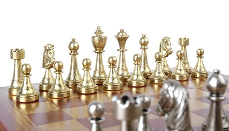 Photo of Set of golden chess pieces on wooden board against white background