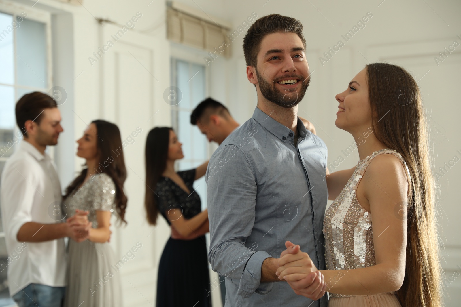 Photo of Lovely young couple dancing together at party. Space for text