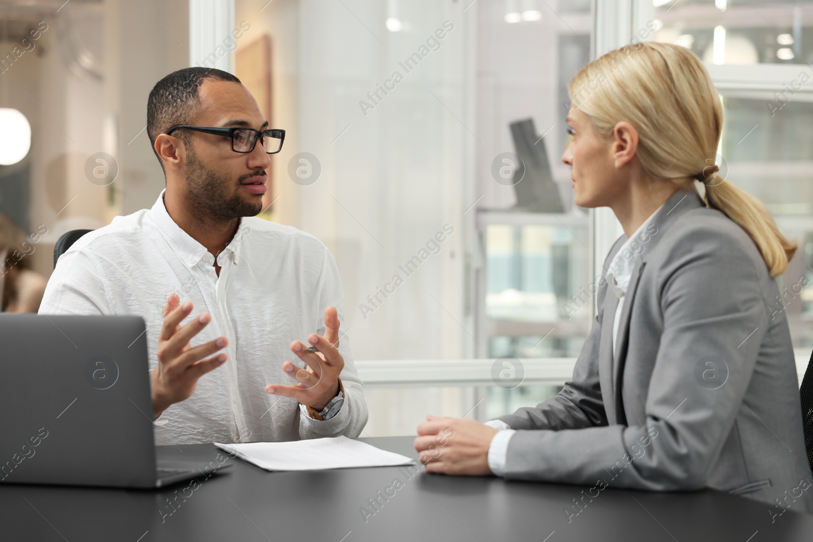 Photo of Lawyers working together at table in office