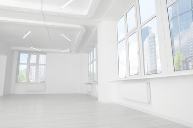 Photo of Modern office room with white walls and windows. Interior design