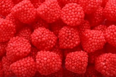 Photo of Delicious gummy raspberry candies as background, top view