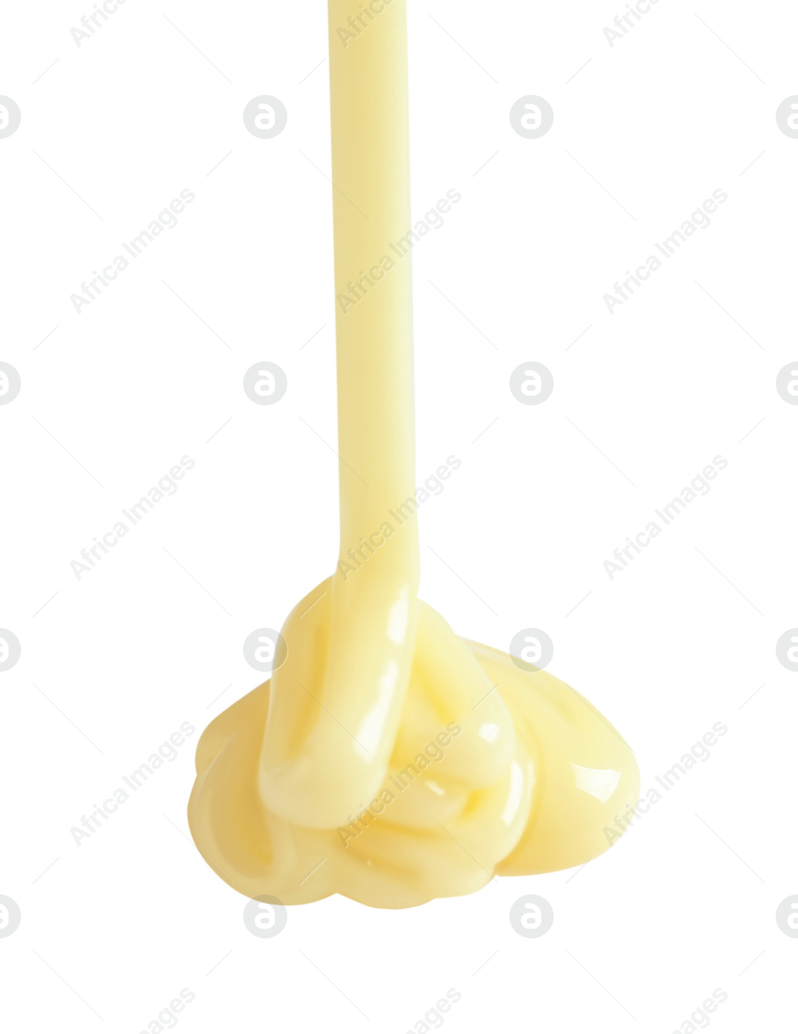 Photo of Tasty pouring condensed milk on white background. Dairy product