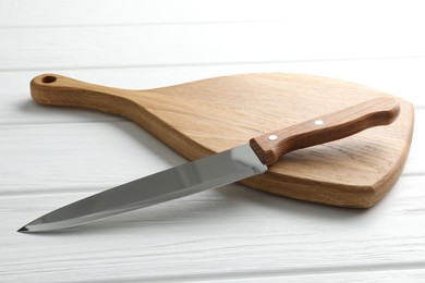 Photo of One sharp knife on white wooden table, closeup