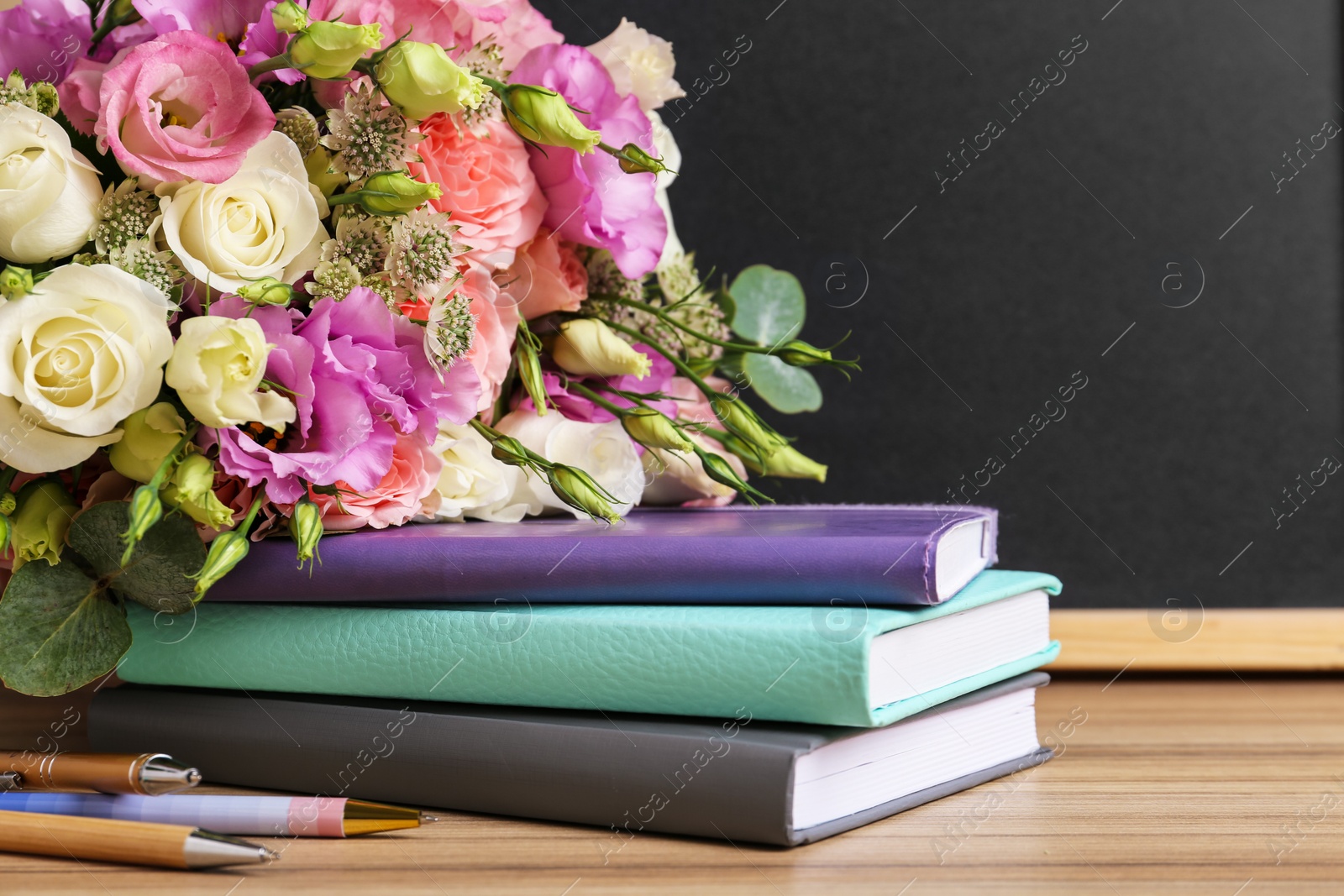 Photo of Composition with flowers for Teacher's day on wooden table, closeup