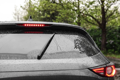 Photo of Closeup view of car window on rainy day, closeup