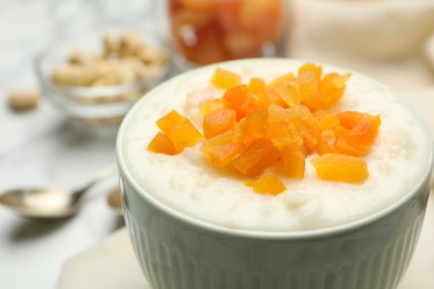 Delicious rice pudding with dried apricots, closeup