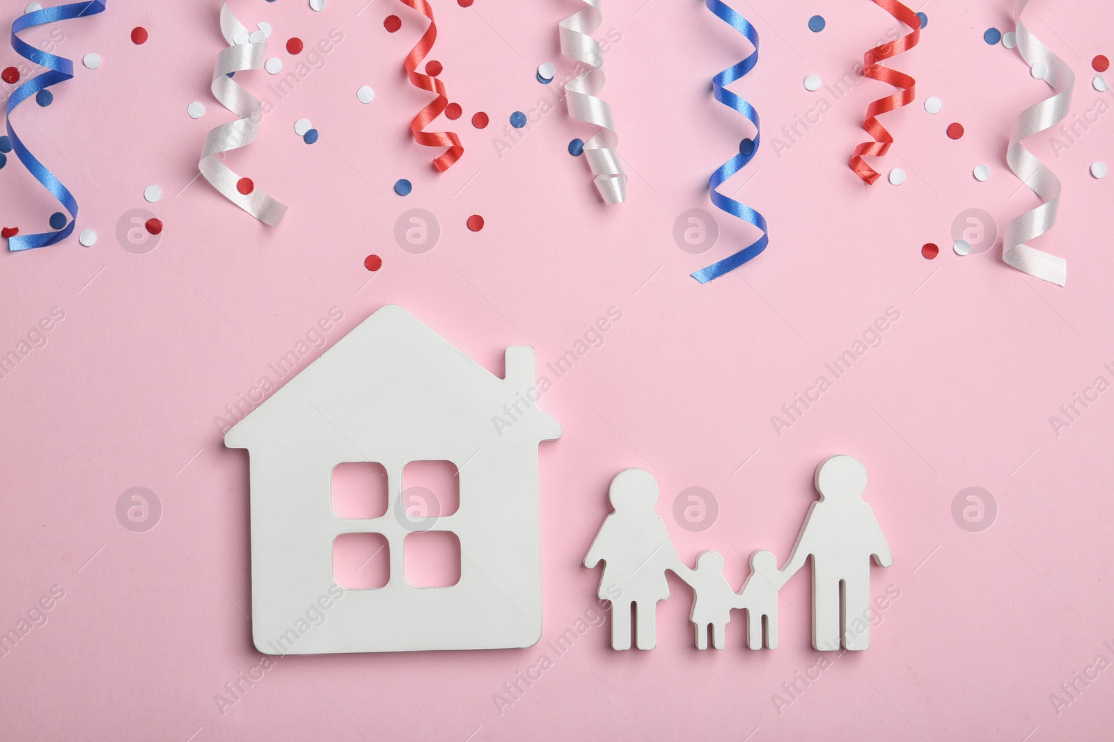 Photo of Flat lay composition with house and family figures on color background. USA Independence Day