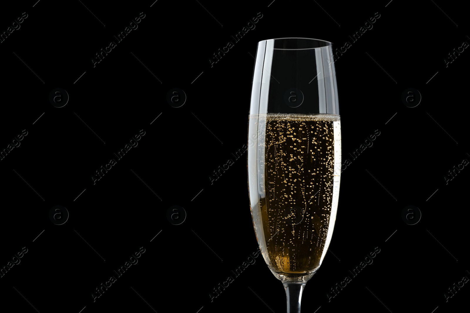 Photo of Glass of fizzy champagne on black background, closeup. Space for text