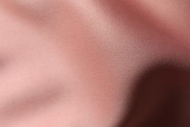 Photo of Texture of pink silk fabric as background, closeup