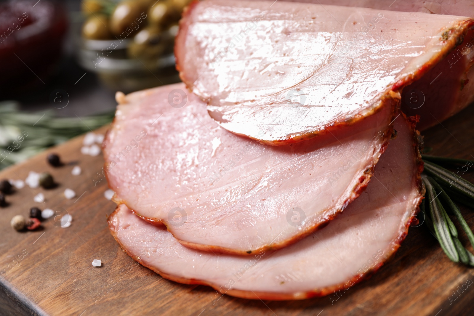 Photo of Delicious cooked ham served on wooden board, closeup