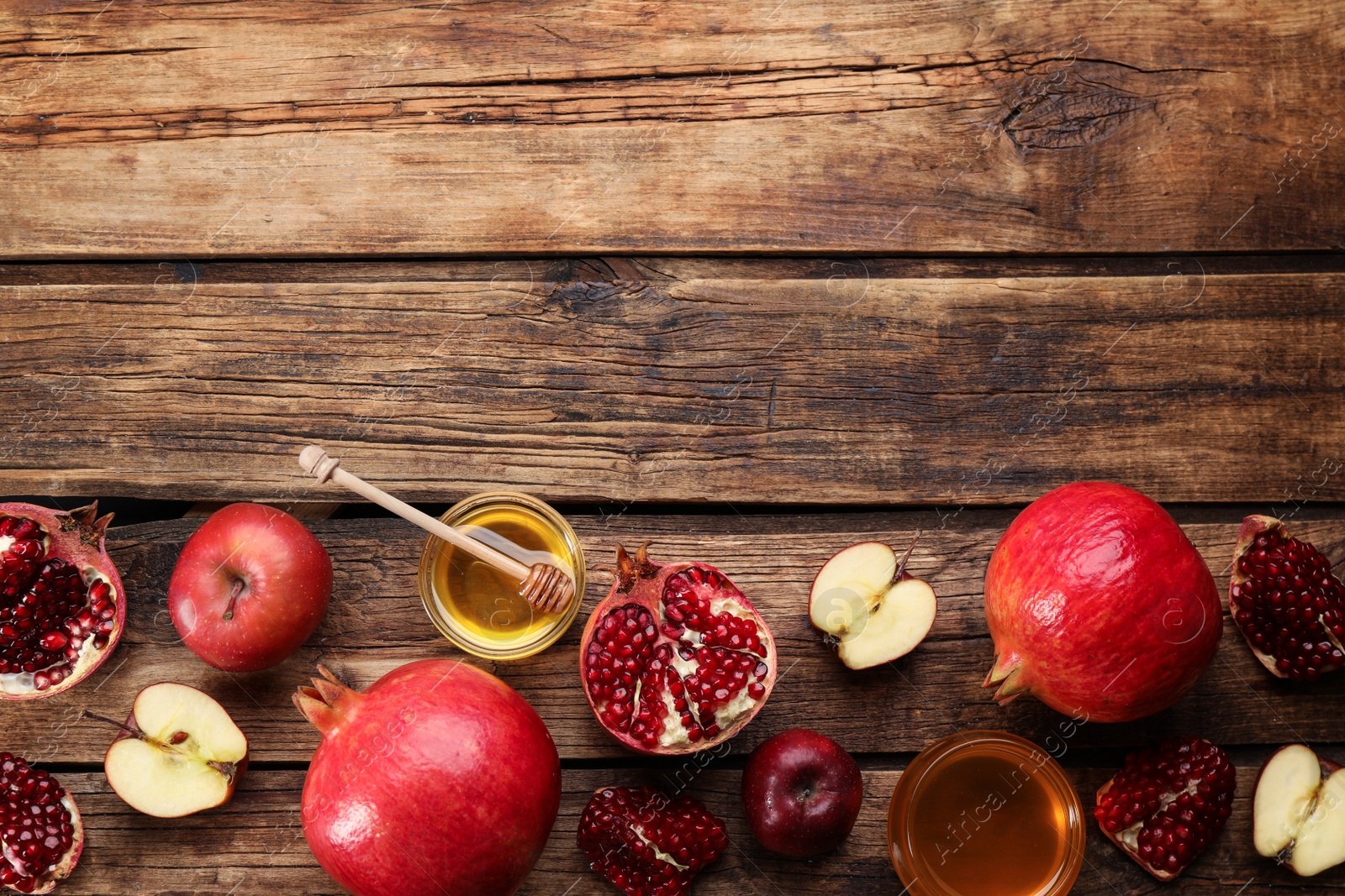 Photo of Flat lay composition with Rosh Hashanah holiday attributes on wooden table. Space for text