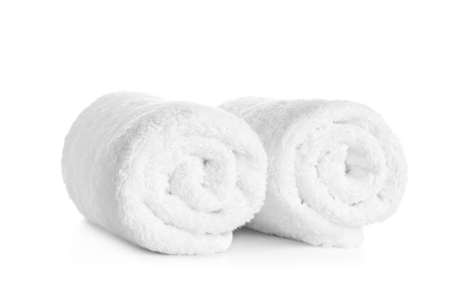 Rolled clean soft towels on white background