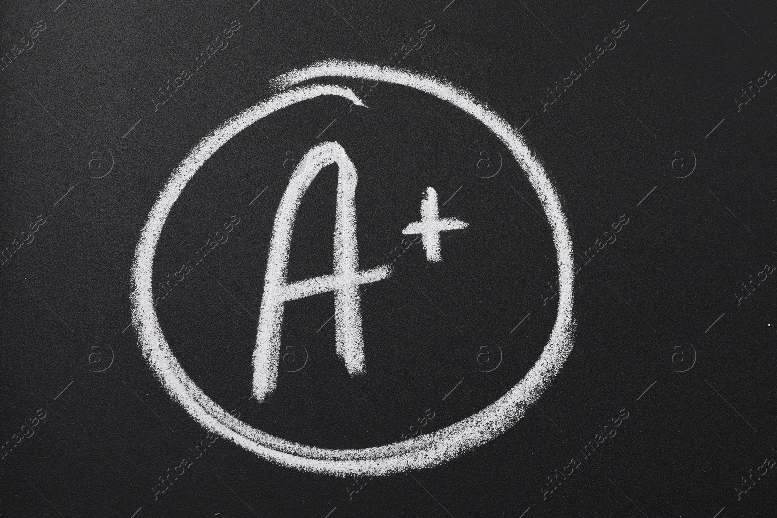 Photo of School grade. Letter A with plus symbol on blackboard, closeup