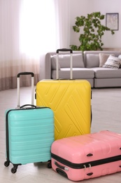 Colorful suitcases packed for journey in living room