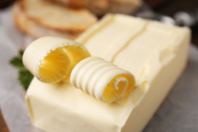 Photo of Tasty butter and curls on table, closeup