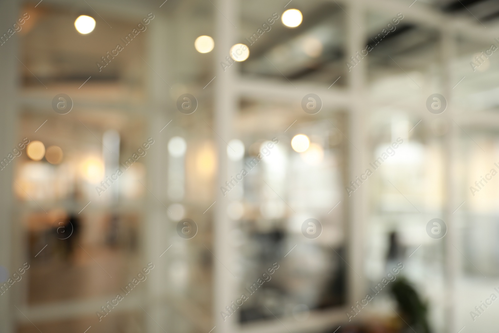 Photo of Blurred view of empty corridor with glass door in company