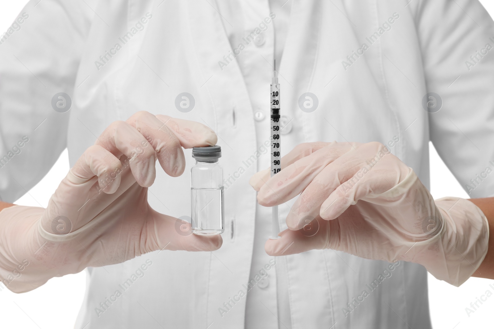 Photo of Doctor holding medical syringe and glass vial, closeup