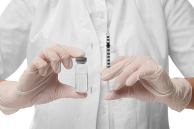 Doctor holding medical syringe and glass vial, closeup