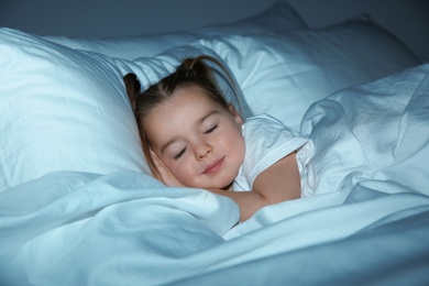 Photo of Beautiful little girl sleeping in bed at night. Bedtime schedule