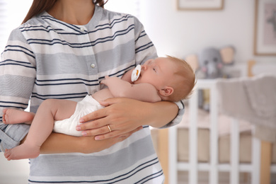 Mother with her newborn baby at home, closeup