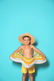 Photo of Cute little boy with inflatable star on color background