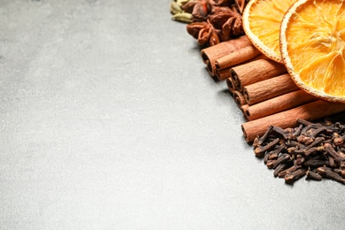 Photo of Different mulled wine ingredients on grey table. Space for text