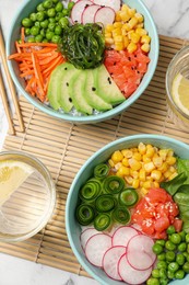 Photo of Delicious salad with salmon and vegetables served on white marble table, flat lay