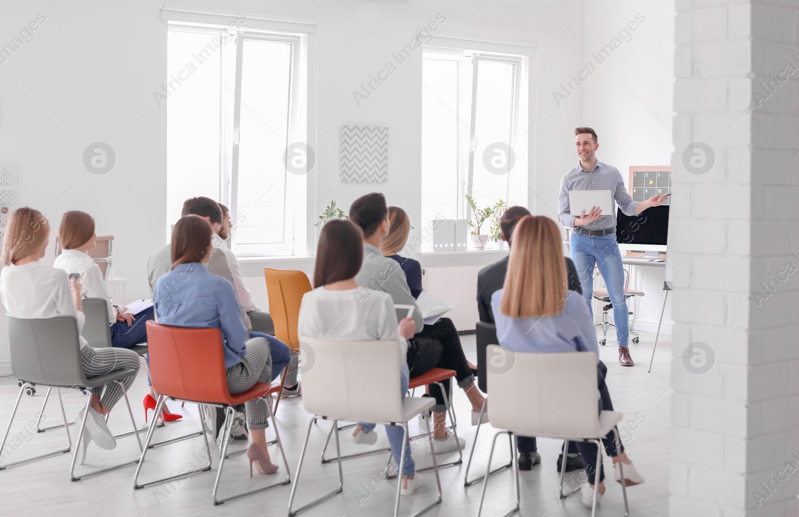 Photo of Male business trainer giving lecture in office