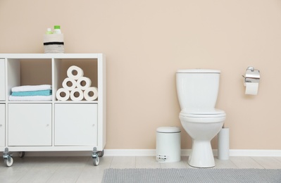 Photo of Modern bathroom interior. Storage of toilet paper rolls