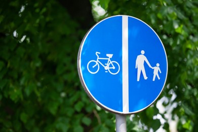 Photo of Traffic sign Compulsory Pedestrian Track and Bicycles outdoors, space for text