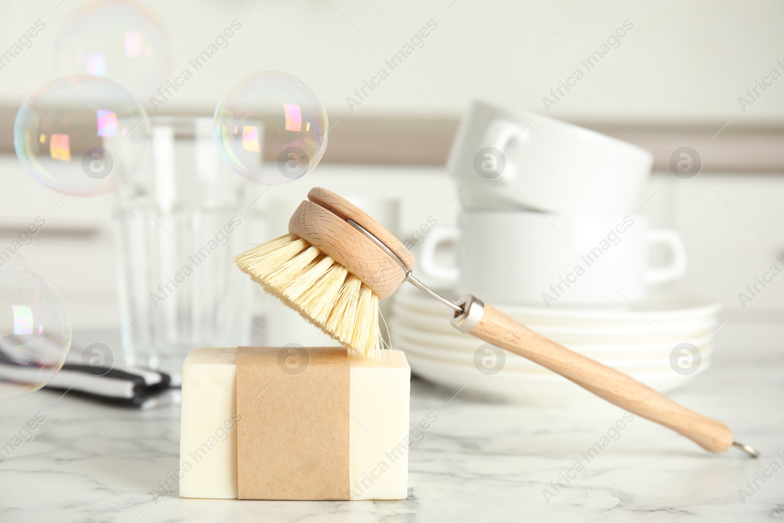 Photo of Cleaning supplies for dish washing and soap bubbles indoors