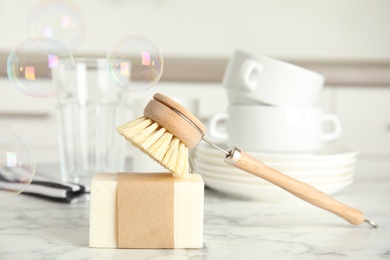 Photo of Cleaning supplies for dish washing and soap bubbles indoors