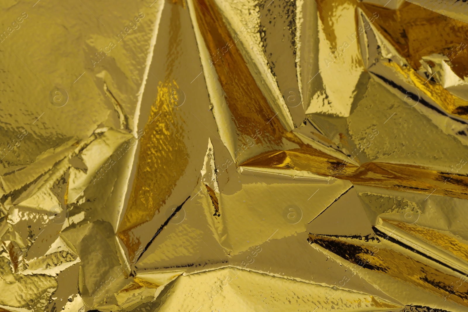 Photo of Edible gold leaf sheet as background, closeup